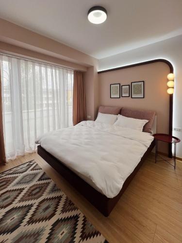 a large bed in a bedroom with a large window at 2001 Central Stay in Peje