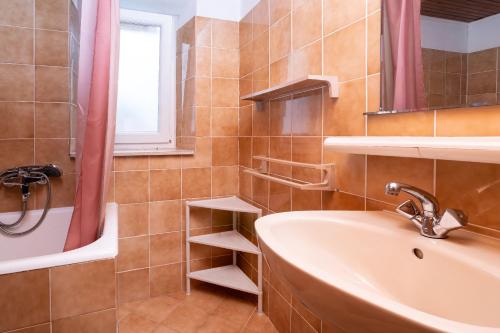 a bathroom with a sink and a window and a tub at Apartment Bezerusa in Igrane