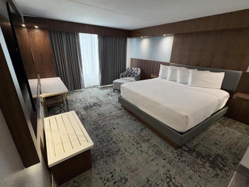 a hotel room with a bed and a chair at Best Western Premier Lakeland North in Lakeland
