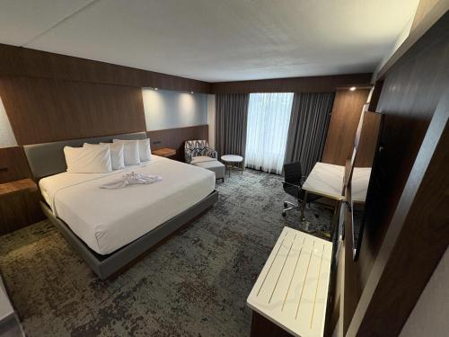 a hotel room with a bed and a desk at Best Western Premier Lakeland North in Lakeland