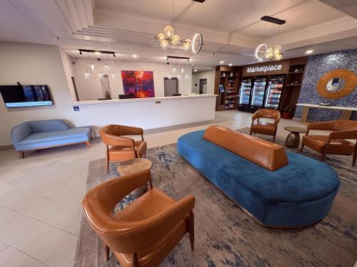 a waiting room with a blue couch and chairs at Best Western Premier Lakeland North in Lakeland