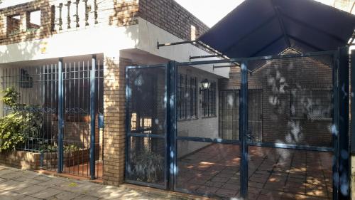 an entrance to a building with a black gate at Casamira in Rosario