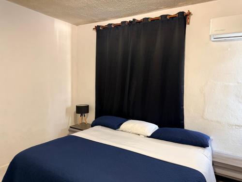 a bedroom with a bed with a black curtain at Departamento completo bien ubicado in Minatitlán