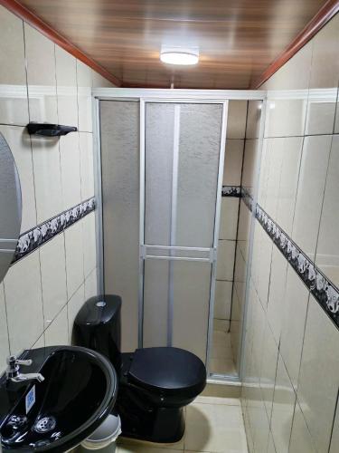 a bathroom with a shower with a toilet and a sink at Apartaestudio equipado en Duitama sector UPTC in Duitama