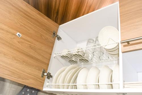 an open refrigerator door with dishes in it at Apartaestudio equipado en Duitama sector UPTC in Duitama