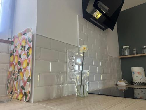a glass vase sitting on a counter in a kitchen at Gîte de La Petite Mauve in Baule