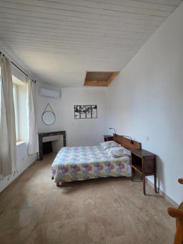 a bedroom with a bed and a desk in it at Gîte Le Campagnard in Saint-Germain-des-Bois