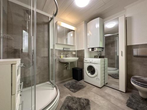 a bathroom with a washing machine and a washer at Haus Anna in Stadlern