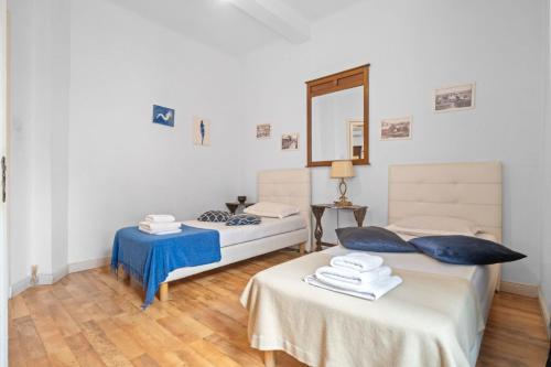 a bedroom with two beds and a mirror at Villa Boema- with parking for large business groups in Bucharest