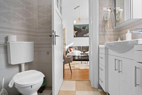 a bathroom with a toilet and a sink at Villa Boema- with parking for large business groups in Bucharest
