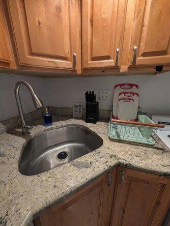 a kitchen counter with a sink and wooden cabinets at Comfortable living, within reach! in Oak Park
