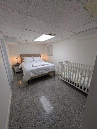 a bedroom with a bed and a crib in it at Comfortable living, within reach! in Oak Park
