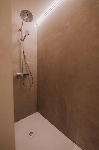 a shower with a shower head in a bathroom at Cozy vibes deluxe in Antwerp