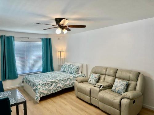 a living room with a couch and a bed at Seashell 8 - Seasonal Rental in Boynton Beach