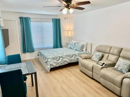 a living room with a couch and a bed at Seashell 5 in Boynton Beach