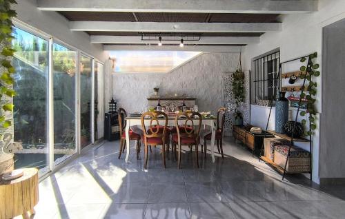 a dining room with a table and chairs at Cozy Home In Guillena in Guillena