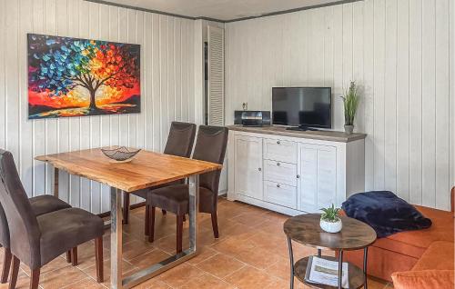 a living room with a table and a tv at Fh Blau in Warenthin