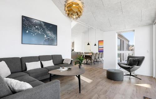 a living room with a couch and a table at Stunning Home In Hasle With Sauna in Hasle
