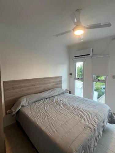 a bedroom with a bed and a ceiling fan at Costumbres Argentinas Dobles En suite in Avellaneda