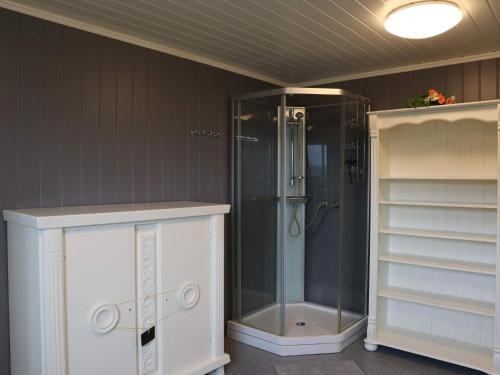 a bathroom with a shower with a glass shower at 7 person holiday home in Risør in Risør