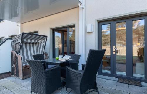 a patio with a table and chairs on a balcony at Baltic in Binz