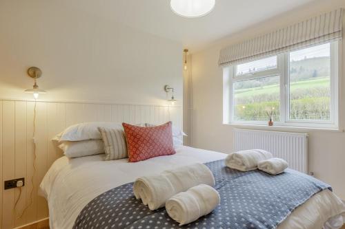 a bedroom with a large bed with pillows on it at 2 Bed in Llangasty oc-d39006 in Llangorse