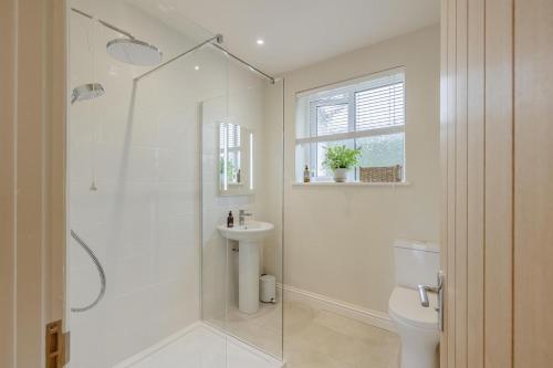 a bathroom with a shower and a toilet and a sink at 2 Bed in Llangasty oc-d39006 in Llangorse