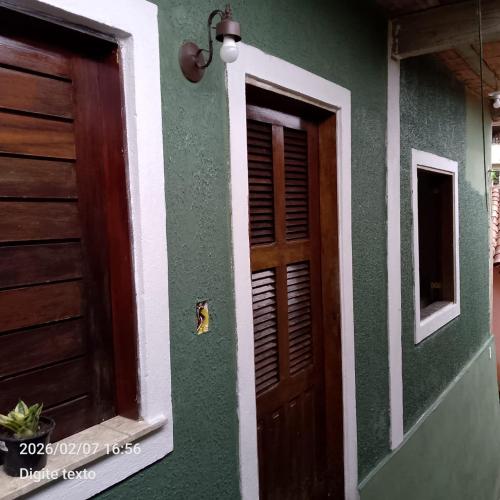 a house with a door and a window at Aconchego particular in Guaramiranga