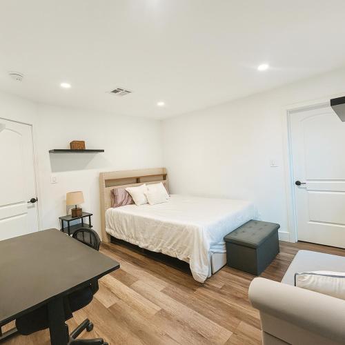 a white bedroom with a bed and a desk at Modern LA Vacation House World Cup in Los Angeles