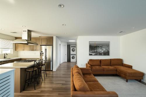 a kitchen and living room with a couch and a table at Modern LA Vacation House World Cup in Los Angeles