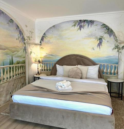 a bedroom with a large bed with a painting at Bridge Apartments in Timişoara