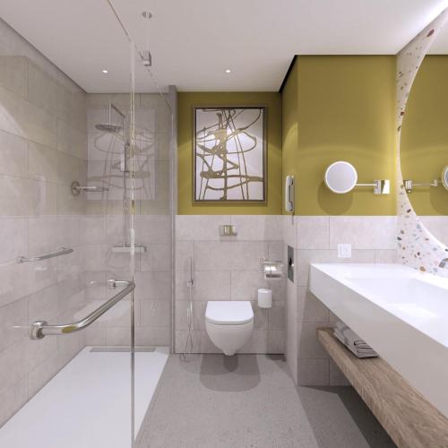 a bathroom with a sink and a toilet and a shower at Hampton By Hilton Jeddah Souq7 in Jeddah