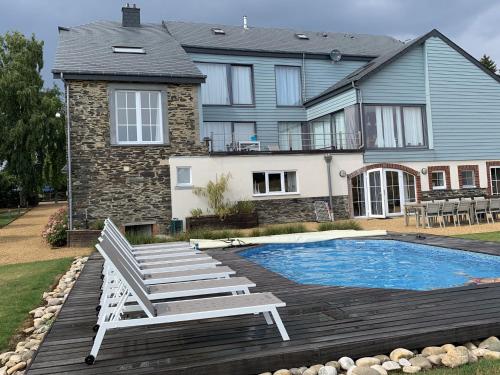 a house with a pool and a chair and a house at Holiday home in Cetturu with sauna in Cetturu
