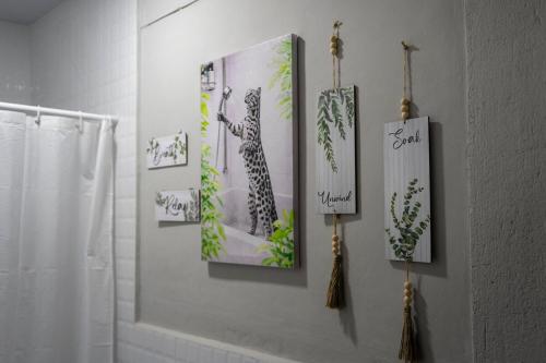 a bathroom with three pictures on the wall at Brisas del Mar, Costa Azul - Private Pool in Acajutla