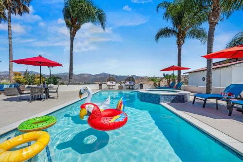 a pool at a resort with two inflatable flamingos at Panorama Peak Luxury Retreat in Poway