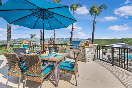 a patio with a table and chairs and a grill at Panorama Peak Luxury Retreat in Poway