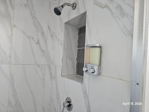 a bathroom with a shower with a mirror at Modern apartment by Playas Bullring in Tijuana