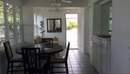 a kitchen and dining room with a table and chairs at Tropical to go! Apt 1 in Fajardo