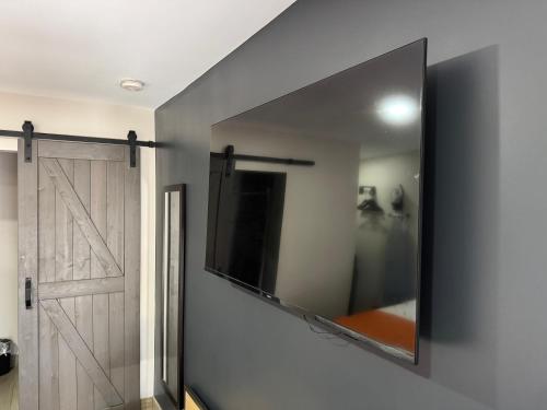 a mirror on a wall next to a sliding door at The Overland Hotel Downtown Flagstaff NAU Conference Center in Flagstaff