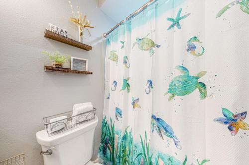 a bathroom with a shower curtain with fish on it at Leeward Cove A8 in Corpus Christi