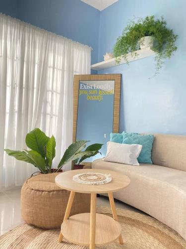a living room with a couch and a table at 2BR w/mini dipping tub + 2 mins to beach in Mati