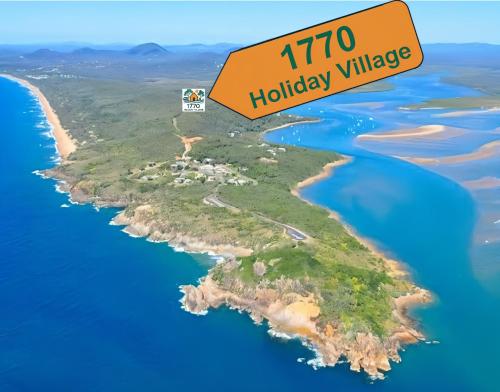 an island in the ocean with a sign that reads holiday village at 1770 Holiday Village in Seventeen Seventy