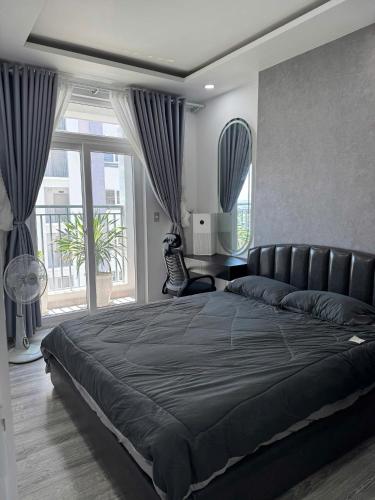 a bedroom with a large bed and a large window at Sun's house in Phan Rang–Tháp Chàm