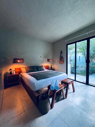 a bedroom with a large bed and a large window at Bernardino in Valladolid