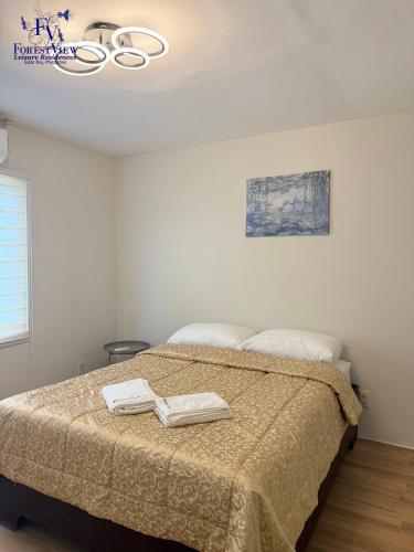a bedroom with a bed with two towels on it at Forest View Leisure Residences in Olongapo
