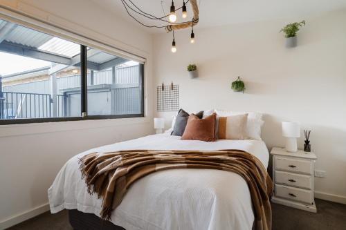 a bedroom with a large bed and a window at Salty Breeze on Graeme in Dromana