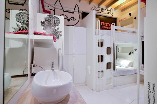 ein Badezimmer mit Waschbecken in einem Zimmer mit Etagenbetten in der Unterkunft Jasaen Hotel in Godown