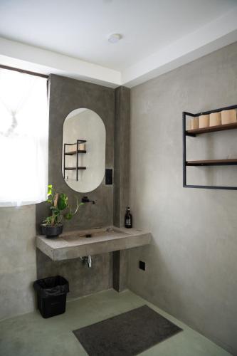 a bathroom with a sink and a mirror on the wall at Ahangama Surf Club in Ahangama