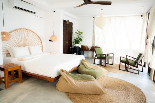 a bedroom with a bed and a table and chairs at Ahangama Surf Club in Ahangama