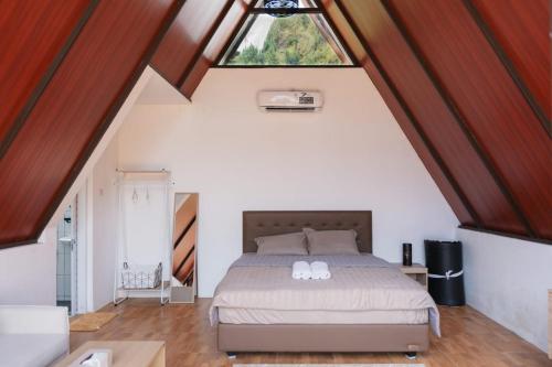 a bedroom with a bed and a window at Sapphire Private Glamping in Bandung